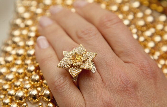 LONDON, ENGLAND - MAY 15: Heather Kerzner poses wearing the George Pragnell Daffodil Ring set with a rare oval fancy vivid orange/yellow diamond donated by jeweller George Pragnell and designed in recognition of Marie Curie's symbolic daffodil, during the Marie Curie Cancer Care Fundraiser hosted by Heather Kerzner at Claridge's Hotel on May 15, 2012 in London, England. The ring was auctioned as part of the Marie Curie Cancer care fundraising dinner. Marie Curie Nurses provide free end of life care to patients with terminal illness in their own homes or in one of their nine hospices. (Photo by Chris Jackson/Getty Images for Marie Curie Cancer Care)